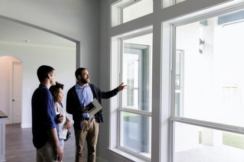 real estate agent shows home to prospective buyers - NAR code of ethics