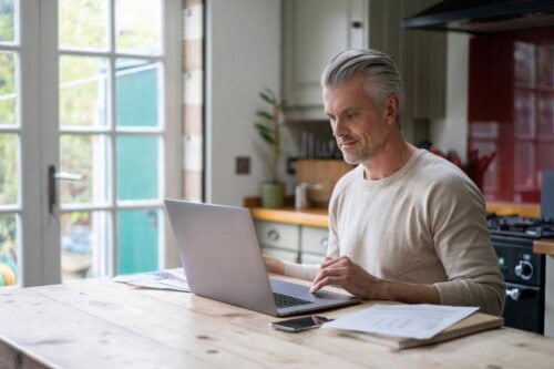 real estate agent at computer - uses marketing strategies to expand his business