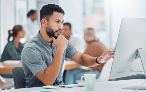 professional sits at desk - office and managerial jobs in real estate