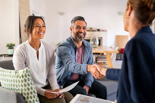 real estate agent and clients meet for negotiating commission rates
